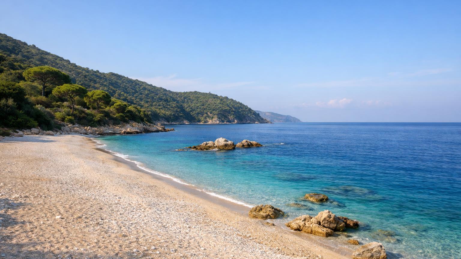 Krorëz Beach pale sand and pine slopes near Sarandë